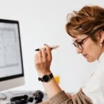 Concentrated adult female thinking about business project in office